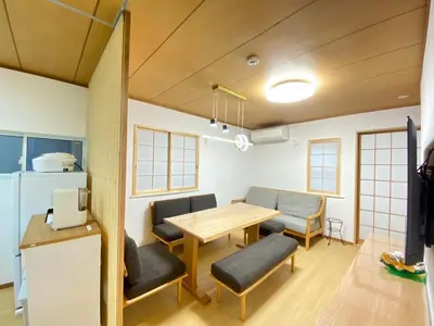 a living room with a table and chairs and a kitchen at N28-Tokyo Shinjuku Luxury Villa 110 SPM in Tokyo