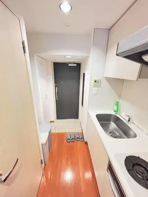 a small kitchen with a sink and a wooden floor at Shibuya\u306e\u5bbf in Tokyo