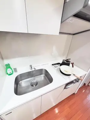 a kitchen with a sink and a stove at Shibuya\u306e\u5bbf in Tokyo