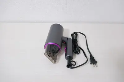 a gray and purple object on a white wall at Sumire in Tokyo