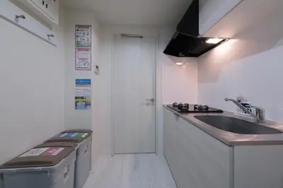 a small kitchen with a sink and a counter top at Sumire in Tokyo