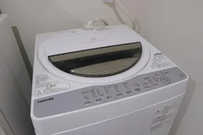a white microwave sitting on top of a washing machine at Sumire in Tokyo
