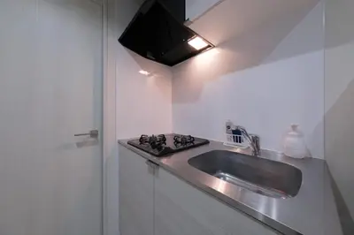a kitchen with a sink and a stove at Sumire in Tokyo