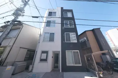 a white and black building on a city street at Sumire in Tokyo