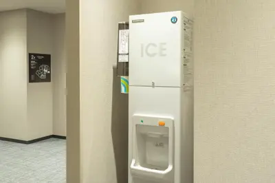 a ice dispenser on the wall of a room at Tosei Hotel Cocone Kamata in Tokyo