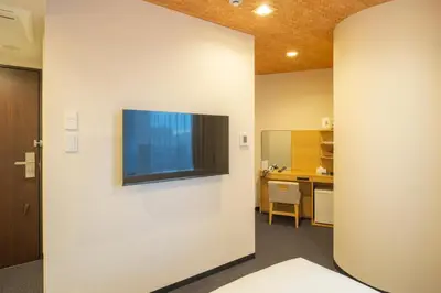 a room with a flat screen tv on a wall at Tosei Hotel Cocone Kamata in Tokyo