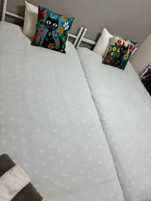 a white bed with two pillows on it at ksmst in Tokyo