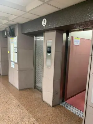 a hallway with two elevators in a subway station at ksmst in Tokyo