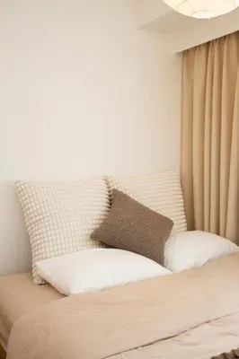 a bed with two pillows on it in a bedroom at M House Tokyo Omori\u99c5 in Tokyo