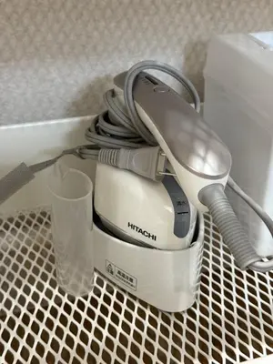 a iron sitting on top of a counter with a glass at M House Tokyo Omori\u99c5 in Tokyo