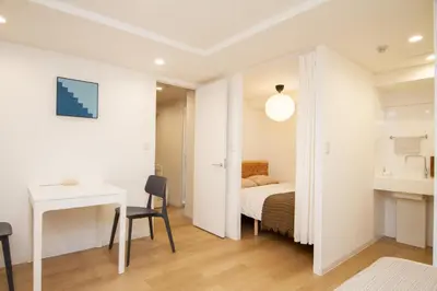 a bedroom with a bed and a desk and a table at M House Tokyo Omori\u99c5 in Tokyo