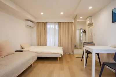 a hotel room with two beds and a desk at M House Tokyo Omori\u99c5 in Tokyo