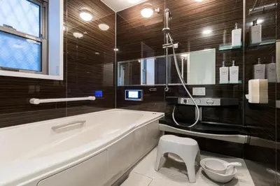 a bathroom with a tub and a toilet in it at Skytree City Suites OSHIAGE in Tokyo