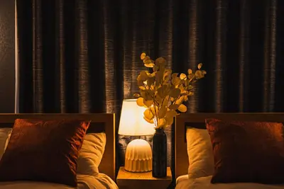 a bedroom with a bed and a vase of flowers at Skytree City Suites OSHIAGE in Tokyo