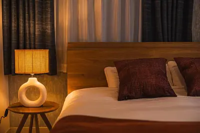 a bedroom with a bed and a lamp on a table at Skytree City Suites OSHIAGE in Tokyo