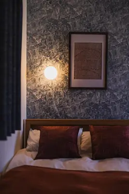 a bedroom with a bed with a picture on the wall at Skytree City Suites OSHIAGE in Tokyo