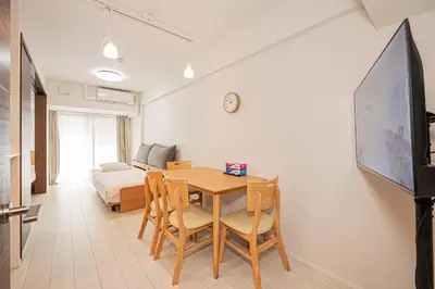 a dining room with a table and chairs and a bedroom at Japan House \u5fa1\u5f92\u753a in Tokyo
