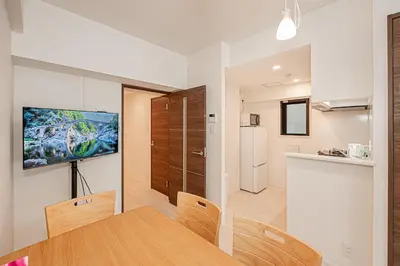 a kitchen and a dining room with a table and chairs at Japan House \u5fa1\u5f92\u753a in Tokyo
