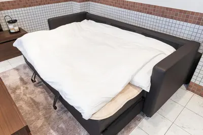 a bed with a white blanket on top of it at Residence Akasaka Comfort in Tokyo