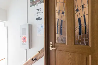 a wooden door with a sign on the wall at Residence Akasaka Comfort in Tokyo