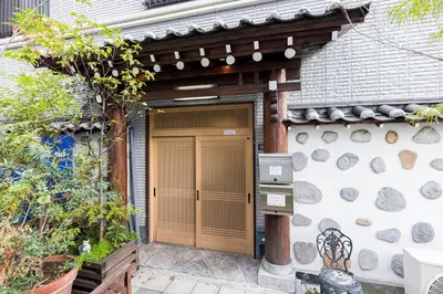 a wooden door of a house with a fence at Residence Akasaka Comfort in Tokyo