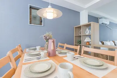 a dining room with a table with plates on it at Residence Shinamachi in Tokyo