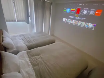 a room with two beds and a sign on the wall at Residence Shinamachi in Tokyo