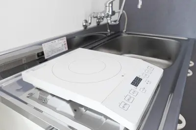 a white machine with a sink in a room at Residence Shinamachi in Tokyo