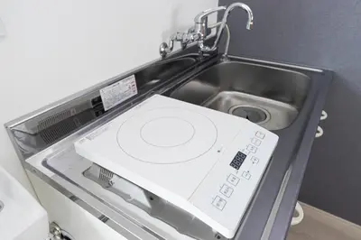 a washing machine in a sink in a kitchen at Residence Shinamachi in Tokyo