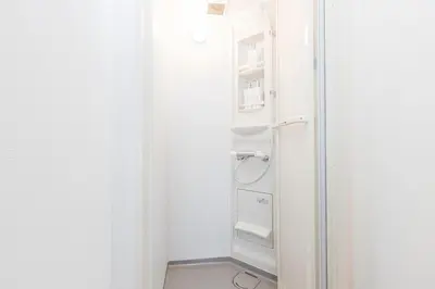 a white refrigerator in a white room at Residence Shinamachi in Tokyo