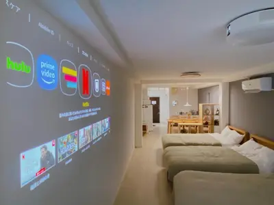 a room with two beds and a wall with a sign at Residence Shinamachi in Tokyo