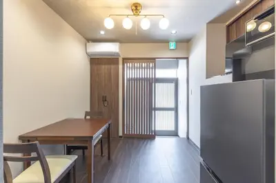a kitchen and dining room with a table and a refrigerator at Asakusa Miyabi no mori in Tokyo