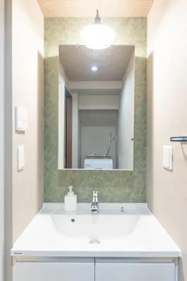 a bathroom with a sink and a large mirror at Asakusa Miyabi no mori in Tokyo