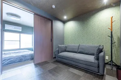 a living room with a couch and a bed at Asakusa Miyabi no mori in Tokyo