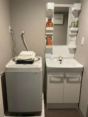 a small bathroom with a sink and a mirror at CAlMU ASAKUSA IMADO HOTEL ASAKUSA UENO IMADOZINZYA TOKYOSKYTREE HANEDA NARITA GINZA TOKYOSTATION Direct \u6d45\u8349\u4e0a\u91ce\u6771\u4eac\u30b9\u30ab\u30a4\u30c4\u30ea\u30fc \u6210\u7530\u7a7a\u6e2f\u7fbd\u7530\u7a7a\u6e2f\u6771\u4eac\u99c5\u76f4\u884c\u30d0\u30b9\u96fb\u8eca\u4fbf\u5229 in Tokyo
