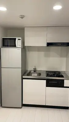 a white kitchen with a refrigerator and a sink at CAlMU ASAKUSA IMADO HOTEL ASAKUSA UENO IMADOZINZYA TOKYOSKYTREE HANEDA NARITA GINZA TOKYOSTATION Direct \u6d45\u8349\u4e0a\u91ce\u6771\u4eac\u30b9\u30ab\u30a4\u30c4\u30ea\u30fc \u6210\u7530\u7a7a\u6e2f\u7fbd\u7530\u7a7a\u6e2f\u6771\u4eac\u99c5\u76f4\u884c\u30d0\u30b9\u96fb\u8eca\u4fbf\u5229 in Tokyo