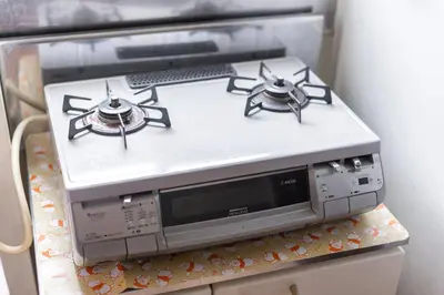 a stove top oven sitting on top of a microwave at Minowa Sta Direct to Ueno in Tokyo