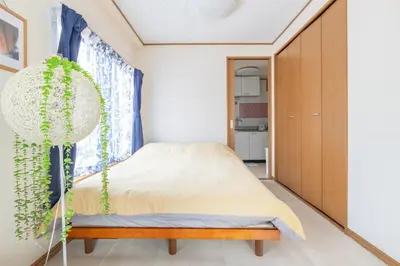 a bedroom with a bed and a plant at Minowa Sta Direct to Ueno in Tokyo