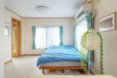 a bedroom with a bed and a window at Minowa Sta Direct to Ueno in Tokyo
