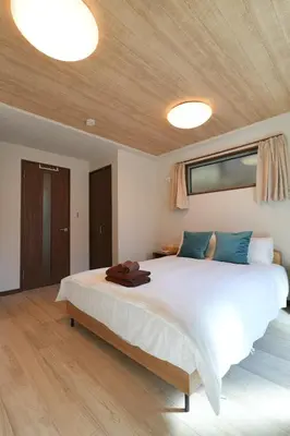 a bedroom with a large white bed with two lights at BRD2143 New built properties 2 mins walk to Shin-Okubo in Tokyo