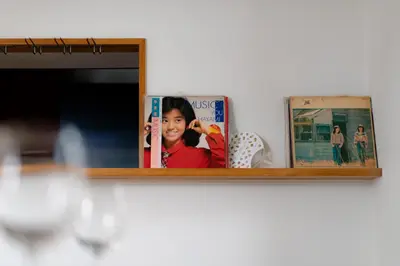 a shelf with books and a picture of a girl at Mita Hillside Villa 4BR 3Bathrooms in Tokyo