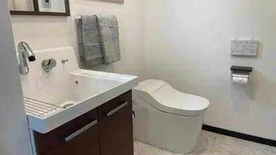 a white bathroom with a sink and a toilet at Mita Hillside Villa 4BR 3Bathrooms in Tokyo