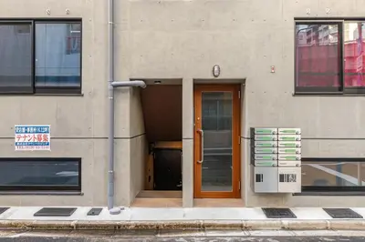a building with a door and a sign in front of it at jtr\u6d45\u8349\u6a4b301 in Tokyo