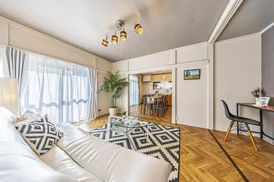 a living room with a white couch and a table at ODYSSEY Tokyo Skytree in Tokyo