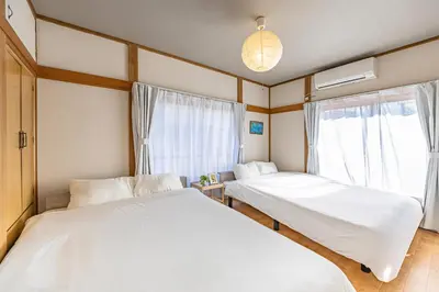 two beds in a room with a window at ODYSSEY Tokyo Skytree in Tokyo