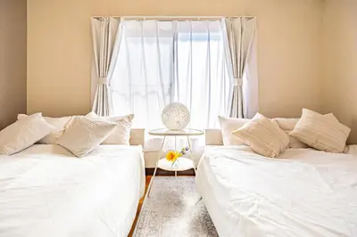 a bedroom with two beds and a window at ODYSSEY Tokyo Skytree in Tokyo