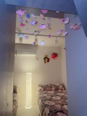 a bedroom with a bed with flowers on the ceiling at Ueno Rose in Tokyo