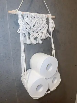 a bunch of rolls of toilet paper hanging from a wall at Ueno Rose in Tokyo