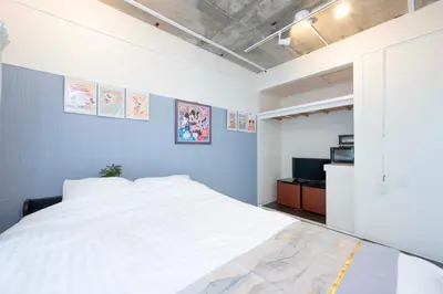 a bedroom with a large white bed and a television at Shibuya Station 8-min walk, Shibuya Center, 3 people stay, WIFI, 4F No elevetor in Tokyo
