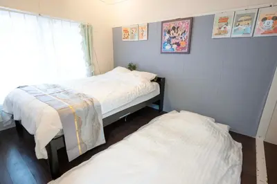 a bedroom with two beds and a window at Shibuya Station 8-min walk, Shibuya Center, 3 people stay, WIFI, 4F No elevetor in Tokyo